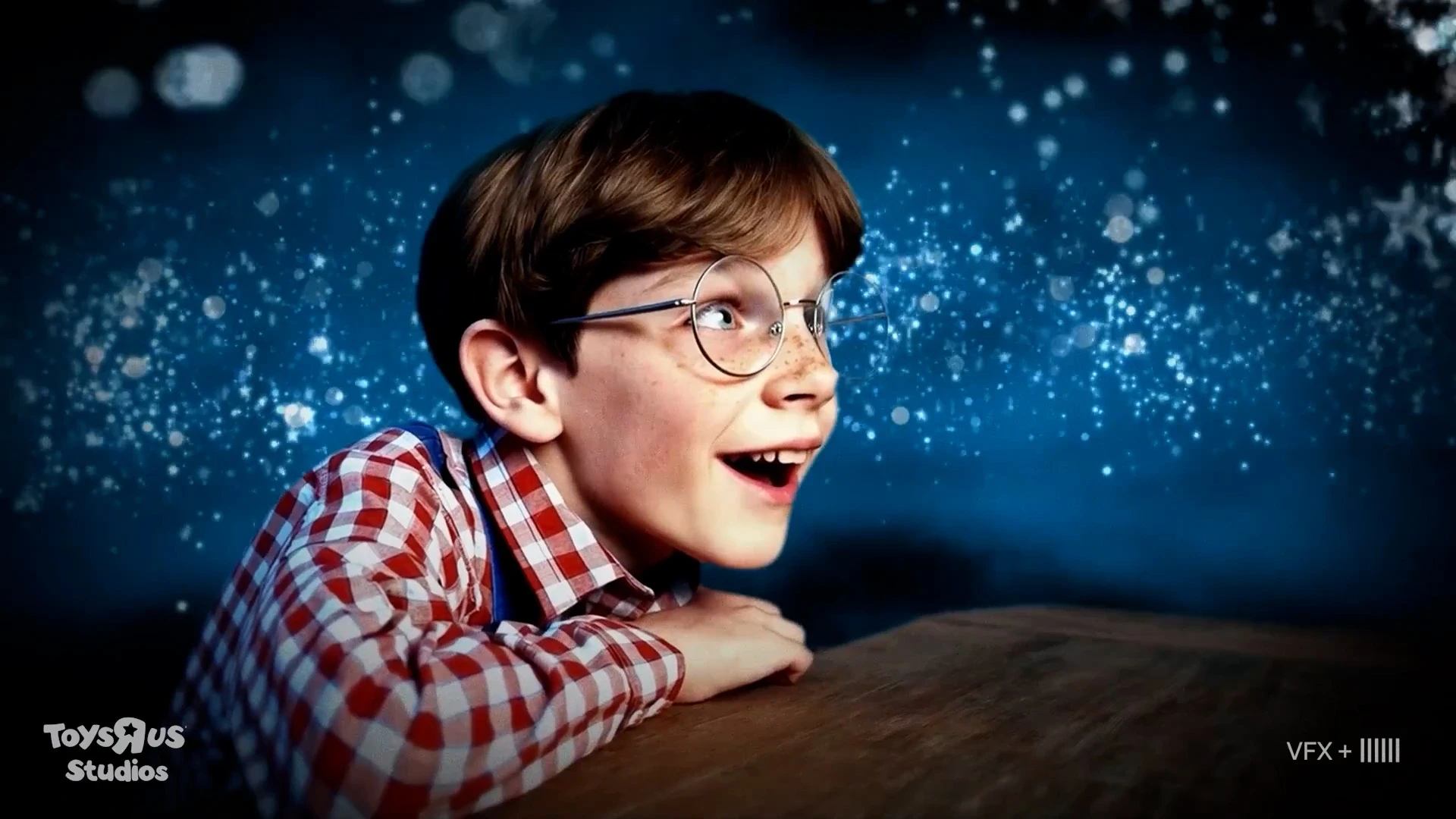 A young boy in a blue-lit bedroom in a frame from the Toys R Us origin film